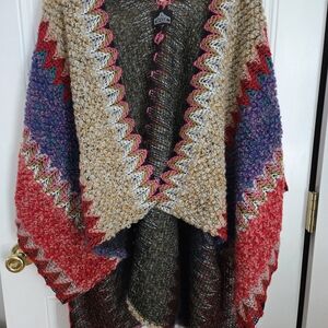 Angie brand knitted poncho cape features a colorful, textured bohemian design